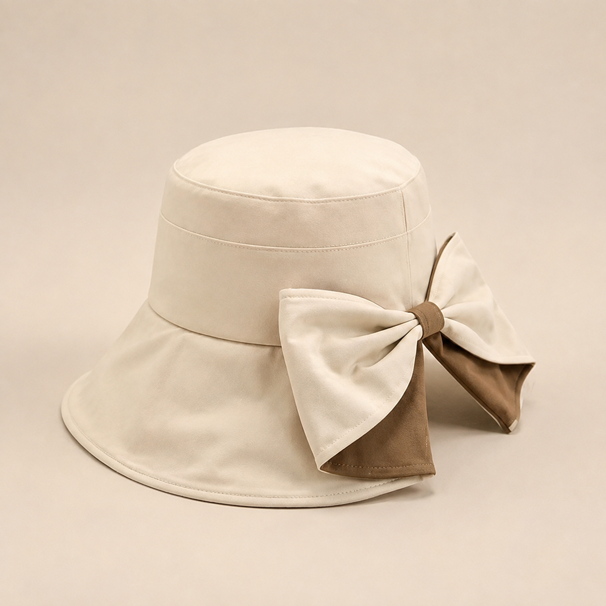 Side view of cream and beige bow-back wide-brim hat