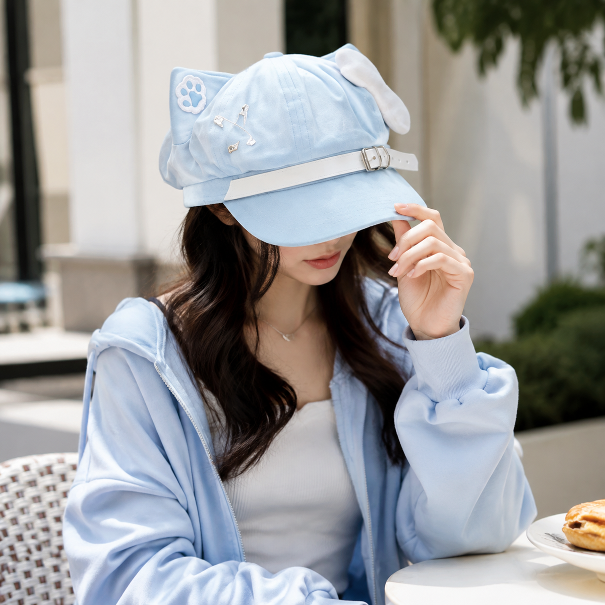 Light-blue cat-ear baseball cap worn outdoors