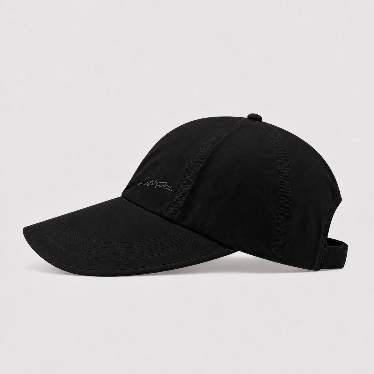 Black lightweight ponytail cap shown from the side